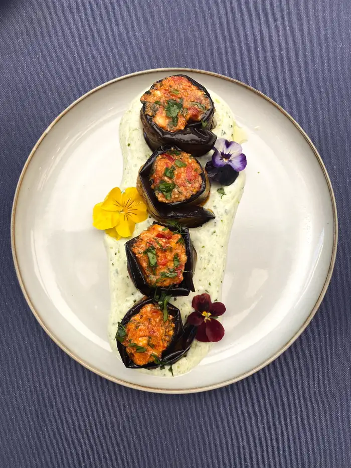 Molasses eggplant rolls with yoghurt and flowers